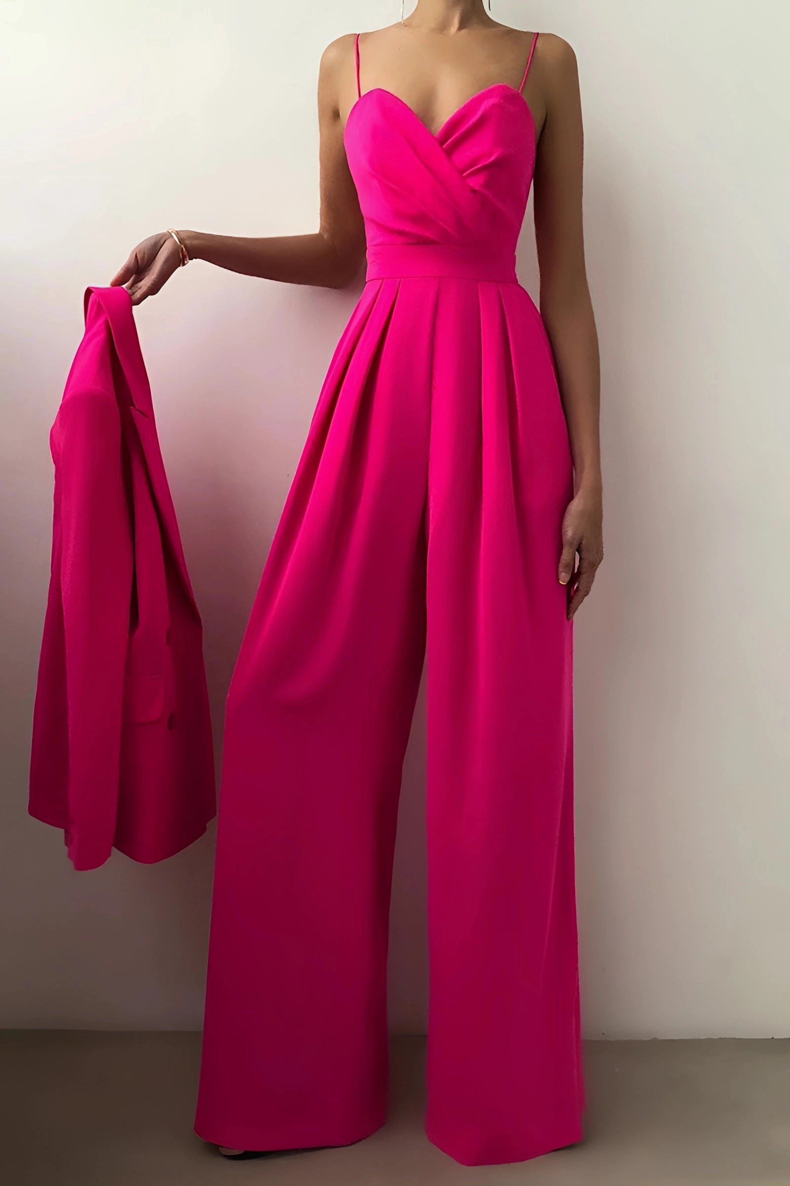 Elegant black wide-leg jumpsuit with formal spaghetti straps and a sweetheart neckline displayed on a mannequin, highlighting the detailed shoulder and arm design.