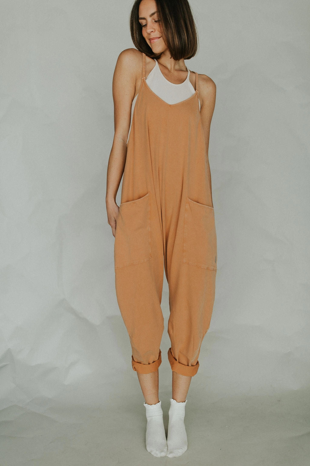 Women's camel sleeveless loose-fit jumpsuit with a lightweight fabric, featuring a relaxed waist, wide legs, and designed for summer wear.